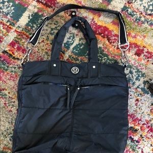 Black nylon lululemon bag that can hold a yoga mat